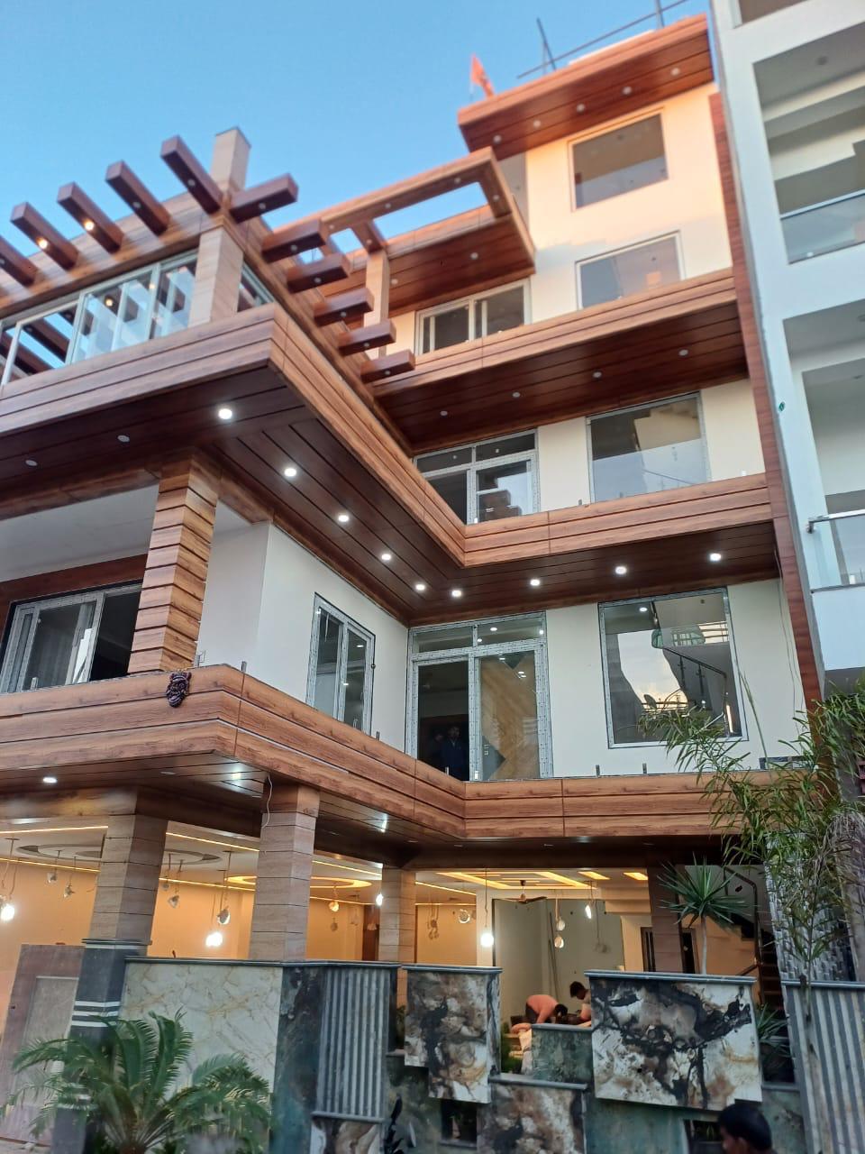 Modern residential elevation with LED accent lighting and wood louvres